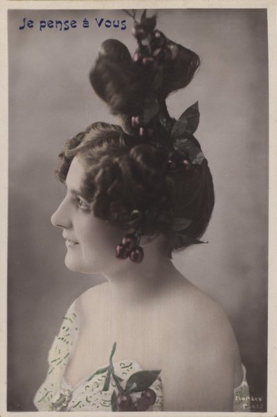 Woman with elaborate hairstyle with cherries by French Photographer